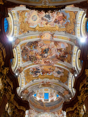 Majestic baroque ceiling in a historic cathedral showcasing intricate frescoes and elaborate...