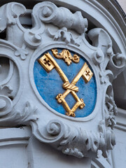 Symbolic architectural detail featuring golden keys on a blue background in a historic setting