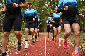 Group of athletic people running in park