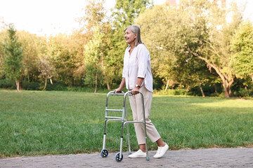 Senior woman with walking frame in park