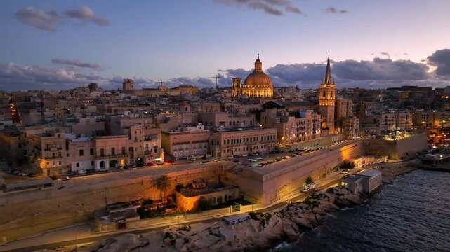 Aerial view of Beautiful sunset over Valletta with historic architecture and coastal view of Malta in the distance