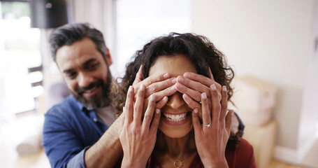 Happy couple, eyes closed and cover with surprise for property, new home or moving in together. Excited man, woman or lovers with gift, house or apartment for anniversary, celebration or renovation