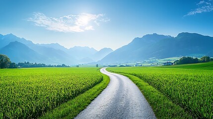 Winding road through idyllic green valley with mountains under a bright summer sky.
