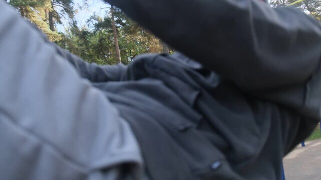 Man doing sit-ups with punches on outdoor gym. Park background. Strength workout. Healthy routine