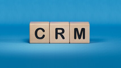 CRM letter on wood block cubes, Customer Relationship Management concept.close up of wooden elements,Business Concept.3D rendering on blue background.