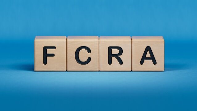 FCRA was created from wooden cubes. Finance and Banking.close up of wooden elements,Business Concept.3D rendering on blue background.