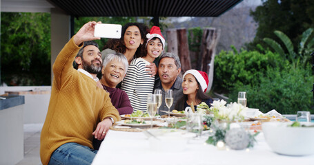 Christmas, smile and family with selfie at lunch by home for holiday memory, profile picture update or funny face. People, parents or grandparents with kids on patio for social event, love or bonding