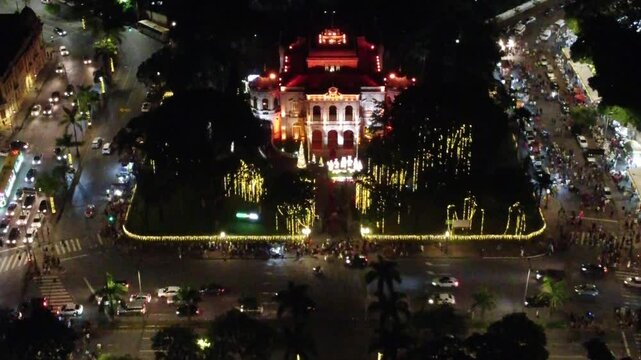 Aerial drone view of Pra&ccedil;a da Liberdade illuminated for Christmas, featuring the stunning Pal&aacute;cio da Liberdade surrounded by festive lights and decorations in Belo Horizonte, Brazil.