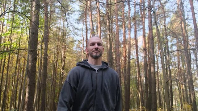 A man walking on a path in an autumn forest