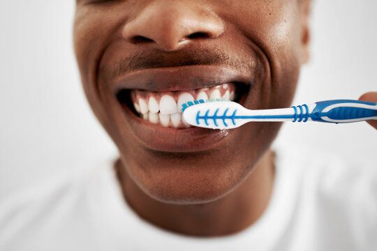 Happy, black man and teeth with toothbrush for dental hygiene, cleaning or oral care at home. Closeup, young African or male person with smile and mouth for tooth whitenening or morning routine