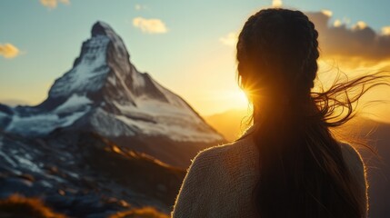 Woman with Braided Hair Silhouetted Against Majestic Matterhorn Sunset in Swiss Alps