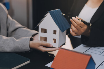 Close up Business people or Real Estate agent explain signing agreement for sale house to client. Property, Insurance, Broker concept.