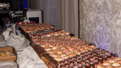 A table full of assorted desserts, including cupcakes and brownies