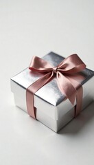 Obraz premium Chocolate gift box with silver foil wrapping and a ribbon tie on a white background, gift wrap, luxury