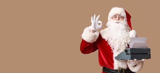 Santa Claus with vintage typewriter showing OK gesture on brown background with space for text