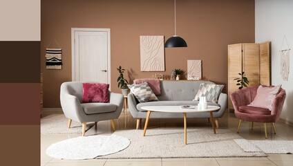 Cozy sofa, armchairs and table in interior of living room. Different color patterns