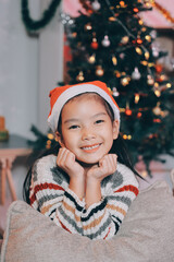 christmas, x-mas, winter, happiness concept - dreaming girl in santa helper hat