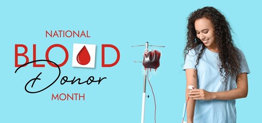Young African-American woman donating blood on light blue background. Banner for National Blood...