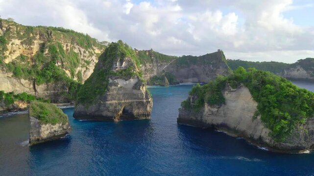 Aerial view of Tropical Island with rocky coastline with blue ocean water. Summer and travel vacation concept.