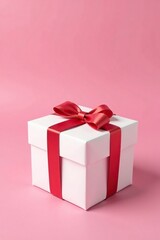 A nicely decorated white gift box wrapped in white paper and tied with a small red bow on a pink background, pink background, birthday, gift box
