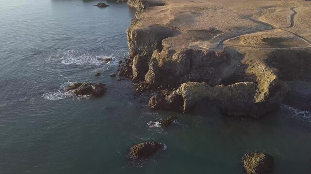Drone aerial landscape winter view of the ocean with sunrise scene on Arnarstapi, Iceland