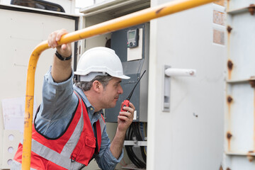 Male electrician checking, repair, maintenance operation electric system in crane construction site