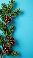 Fototapeta premium Pine branch arrangement on a blue background with pinecones and pine needles, decor, blue, nature