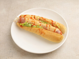 Hotdog with mayonnaise and ketchup drizzled on white background