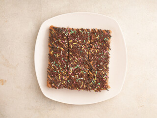 Chocolate sponge cake on white plate