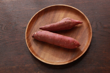 木の皿の上のさつまいも