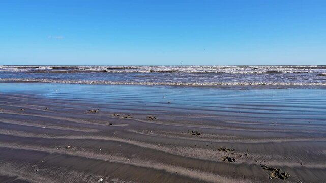 Surfside Beach in Galveston TX, consistent waves, shoreline, seagulls