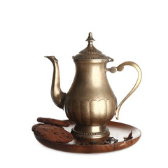 Teapot with cookies and dry tea on white background