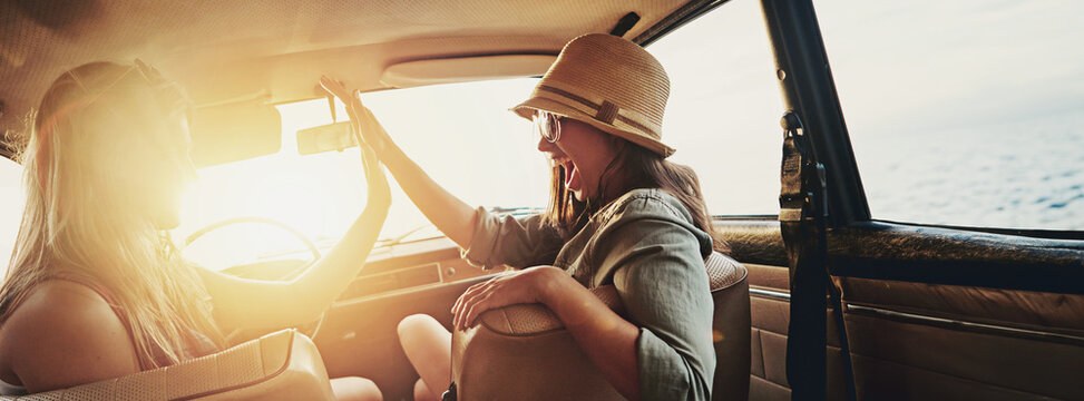 Happy women, high five and sunset with car for road trip, travel or holiday getaway together. Banner, female people or friends with lens flare or vehicle for summer vacation, adventure or journey - Powered by Adobe
