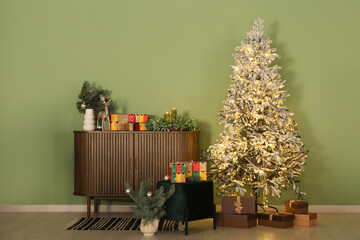 Interior of living room with drawers, glowing Christmas tree and Advent calendar