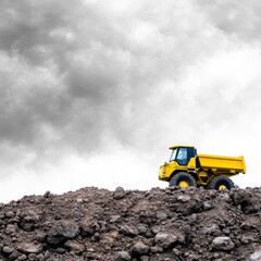 Yellow Dump Truck on a Hill Under Cloudy Sky