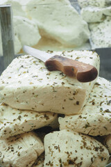 Delicious Fresh Herbal Cheese Served with a Classic Wooden Knife