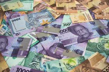 Various Colorful Indonesian Rupiah Banknotes Displayed in a Scattered Arrangement