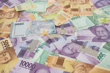 Various Colorful Indonesian Rupiah Banknotes Displayed in a Scattered Arrangement