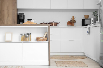 Interior of stylish kitchen with coffee pot and pancakes on island table