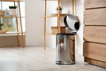 Trash bin with foot pedal in living room