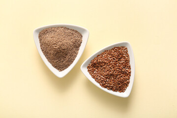Bowls of flax seeds and flour on beige background