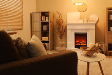 Interior of cozy living room with fireplace, armchair and coffee table