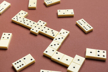 Many white dominos blocks on brown background
