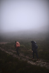 Obraz premium People, hiking and outdoor mountain for exercise, extreme terrain and nature for winter adventure. Back, friends and trekking journey on remote vacation, explore mockup space and together on trip