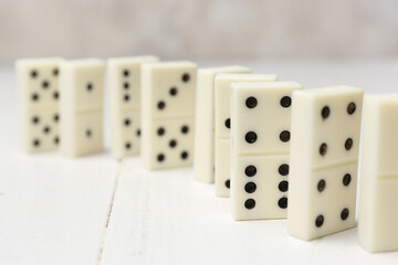 Many dominos blocks on white wooden table