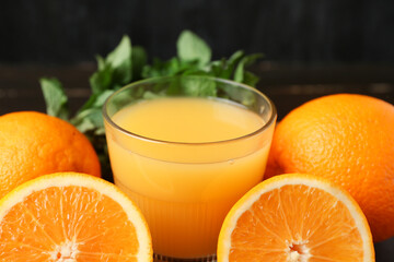 Glass of tasty juice with oranges and mint leaves, closeup