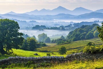 Obraz premium scenic view of rolling hills and misty mountains in distance with foreground in focus and background blurred plenty