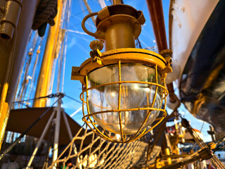 Old lantern and ropes stretched across the masts of an old ship