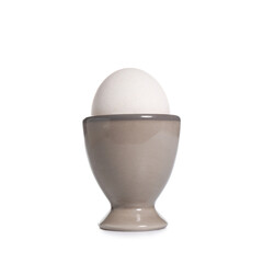 Ceramic holder with chicken egg isolated on white background