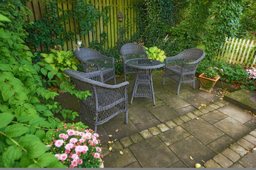 Gardening, table and chairs with nature, empty and environment with countryside. Growth, ergonomics and eco friendly with peace, calm and carefree with plants, flowers and furniture with leaves